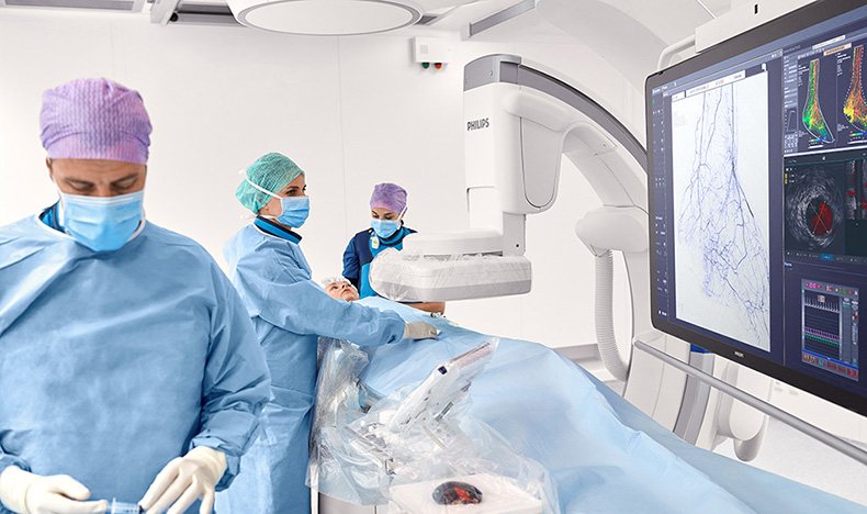 Interventional physicians performing a procedure on a patient