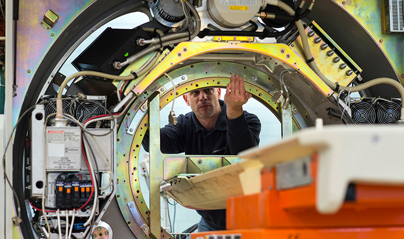A technician working on a refurbished medical system